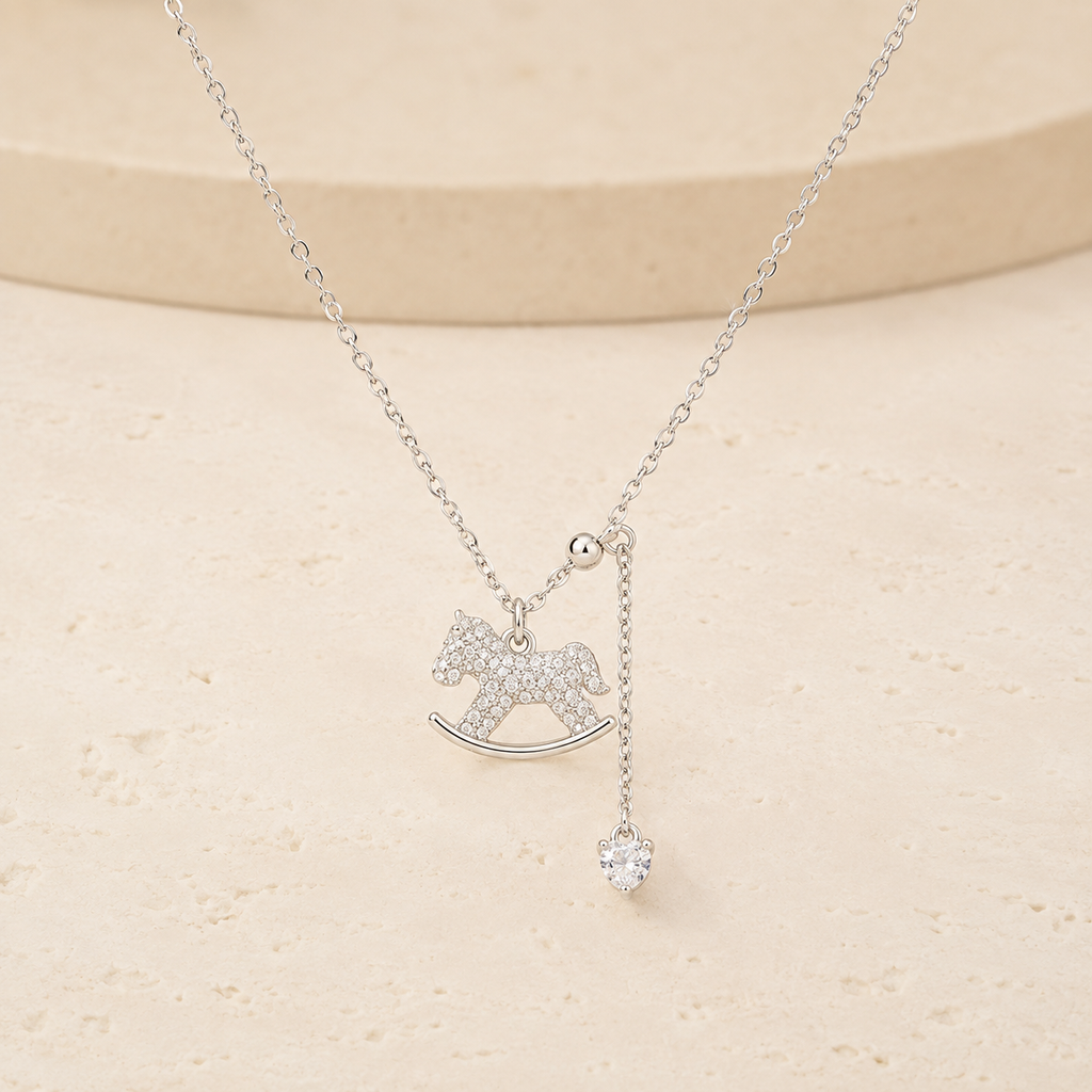 Lucky Rocking Horse Necklace on a warm ivory studio background