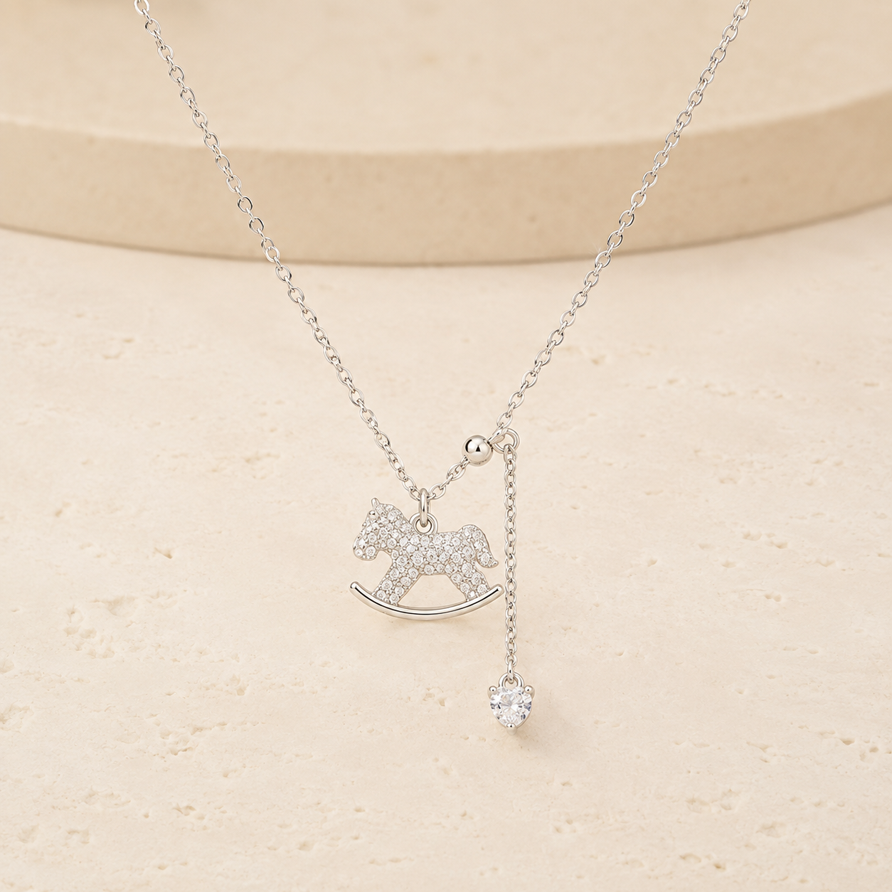 Lucky Rocking Horse Necklace on a warm ivory studio background